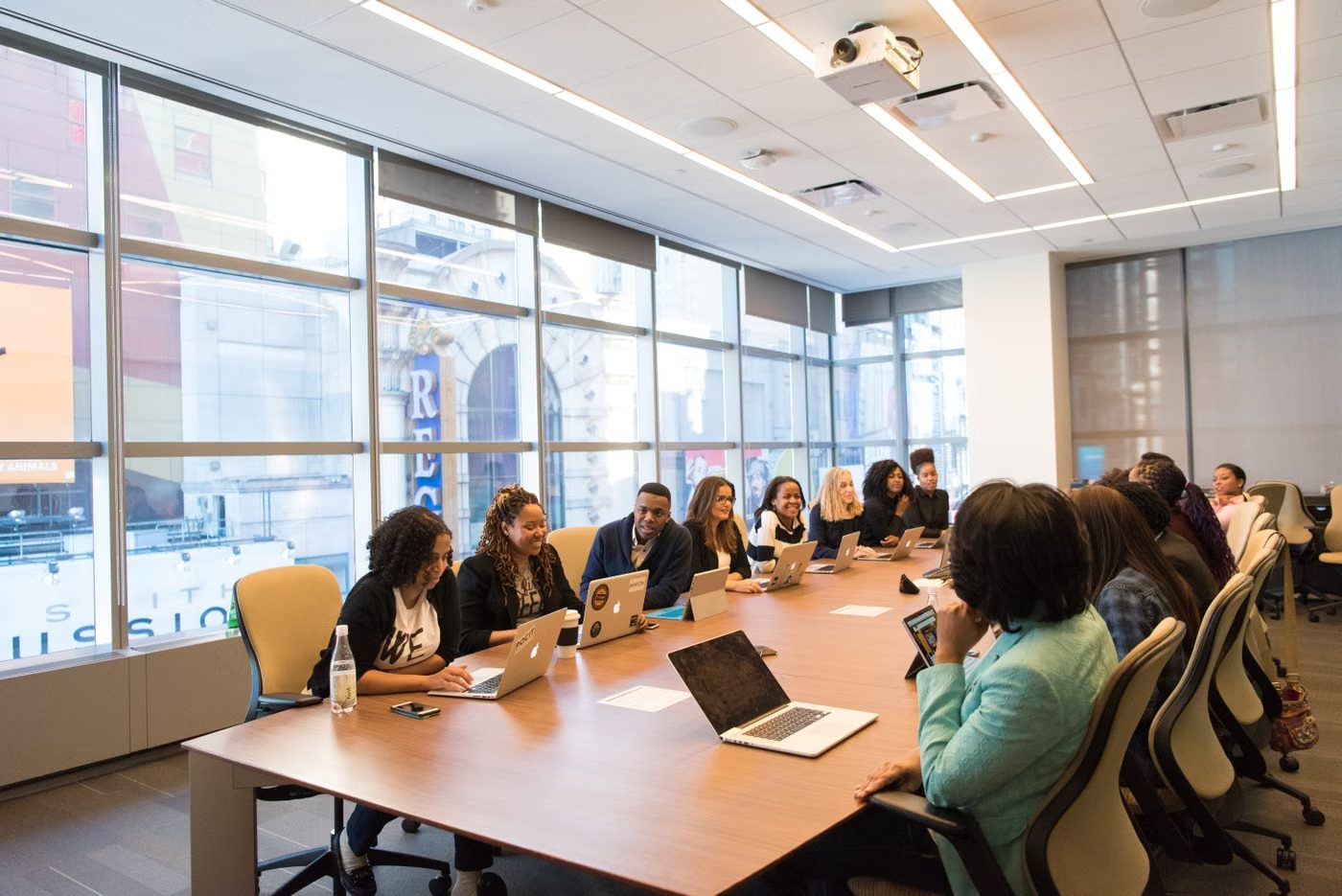 Stakeholders seated around a long boardroom table