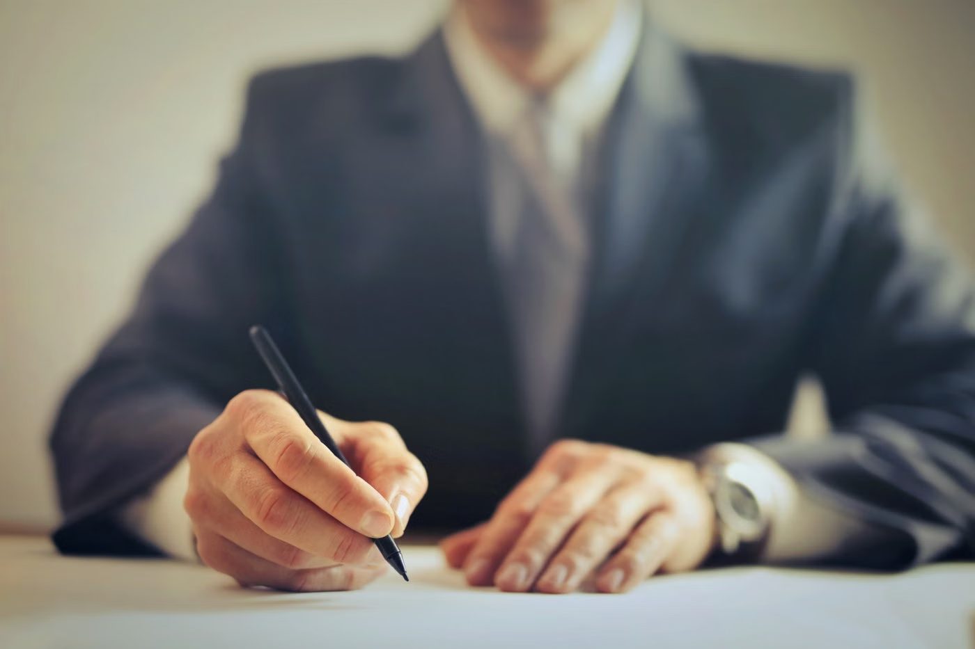 Executive signing documents at a desk